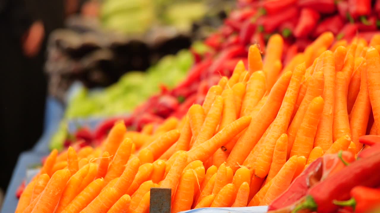 Close-up of Fresh Carrots and Vegetables on Display at a Market Stall