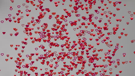 animación de múltiples corazones rojos flotando sobre un fondo gris