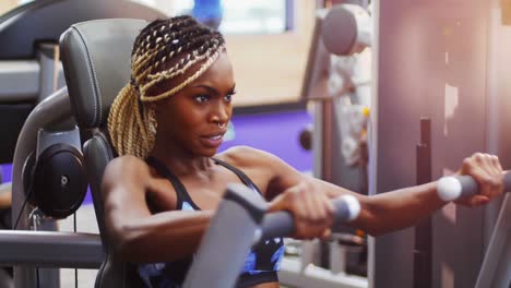 fit woman exercising on chest press machine