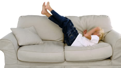 boy jumping on the sofa on white background