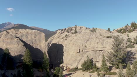 Aerial-shot-pulling-back-from-a-mountain-to-reveal-a-beautiful-mountainous-habitat-in-Colorado's-rural-country