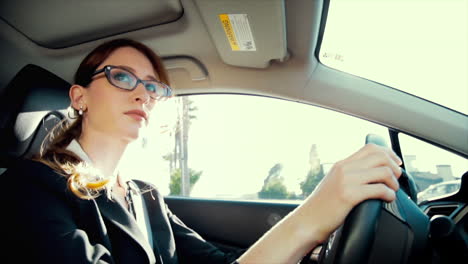 business woman driving with a neutral expression