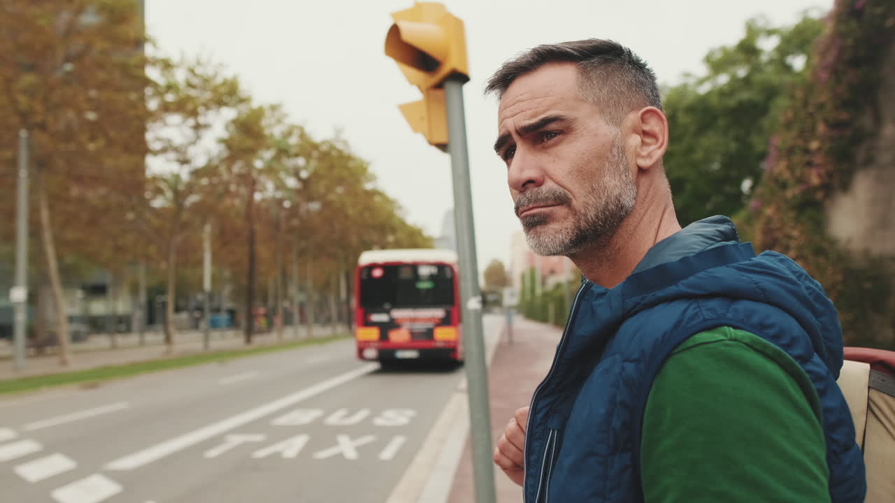 Man waiting at a crosswalk in the city
