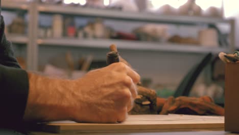 close-up of a man's hands sketching a design on paper