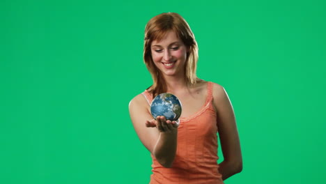 woman holding a globe in her hand