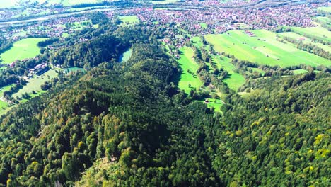 aerial-flight-over-green-valley-and-small-villages,-4k