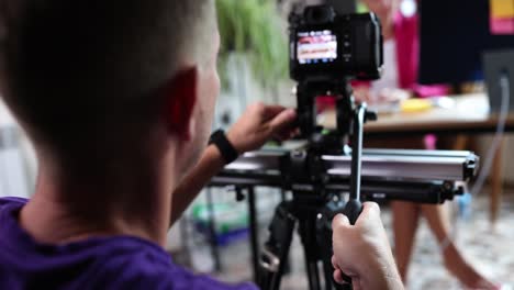 cameraman operating a professional video camera on a slider