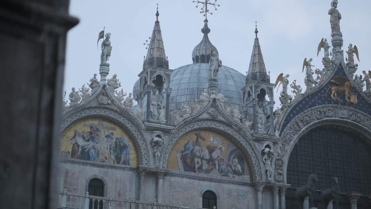 Smooth gimbal shot of Basilica di San Marco in Venice between pillars