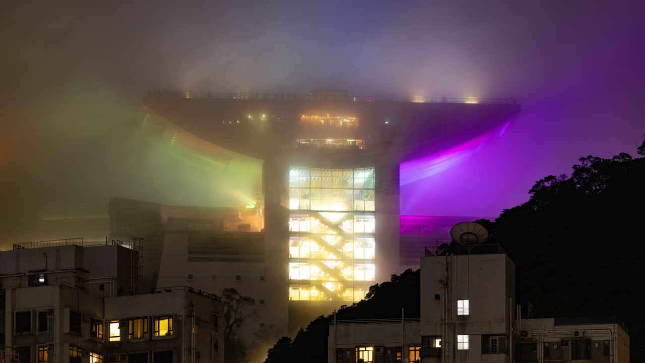 HONG KONG - 19 MARCH 2025 : Timelapse of the Hong Kong city skyline at night with the peak in the background