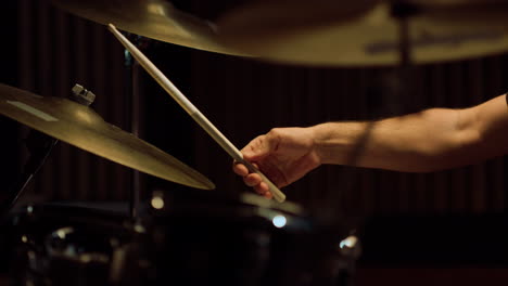 drummer hands playing on percussion instrument in recording studio