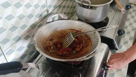 close-up-of-hands-cooking-meat-on-the-stove