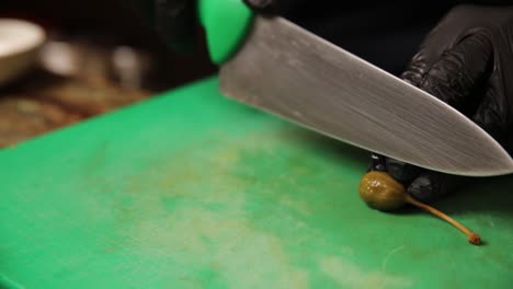 chef cutting capers