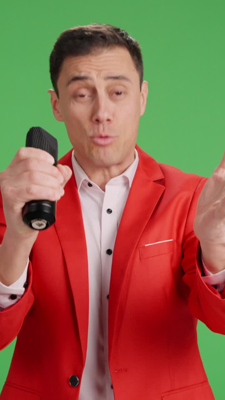 Enthusiastic showman introducing performer on green screen