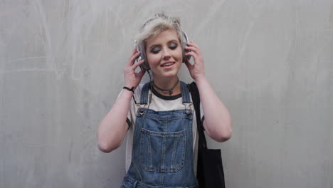 portrait-cute-young-woman-takes-off-earphones-enjoying-listening-to-music-wearing-stylish-fashion-confident-female-student-urban-youth