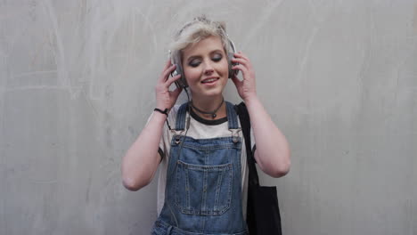 portrait cute young woman takes off earphones enjoying listening to music wearing stylish fashion confident female student urban youth