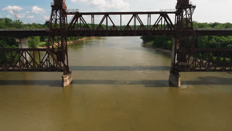 rusty truss train lift bridge over white river near twin city riverfront park, de valls bluff, arkansas, usa - aerial fly-under