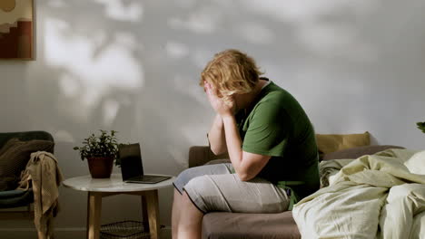 young man waking up and sitting