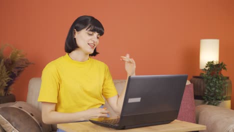 Woman-looking-at-laptop-is-happy-and-dancing.