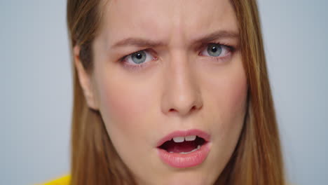 closeup angry woman waving head on camera in studio. sarcastic woman face