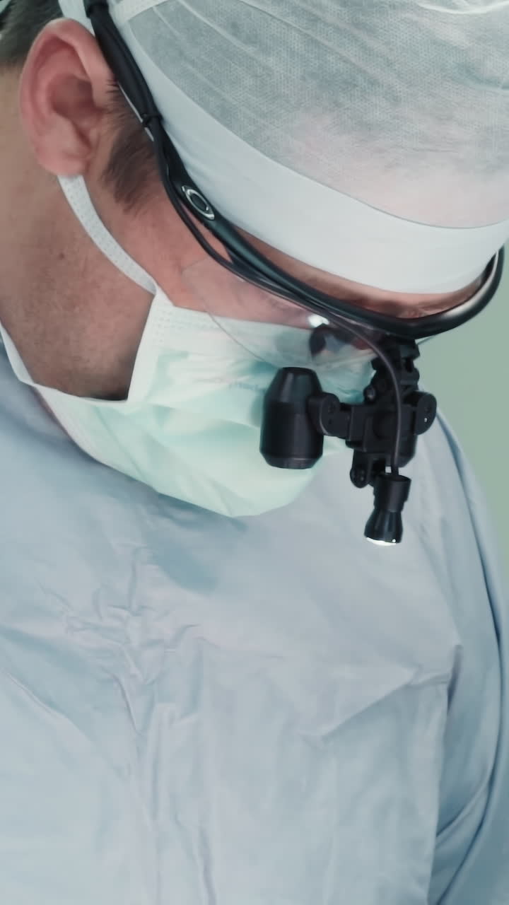 Surgeon with assistant performs surgery. Surgical team in sterile uniform and professional equipment treats coronary artery disease in surgery room