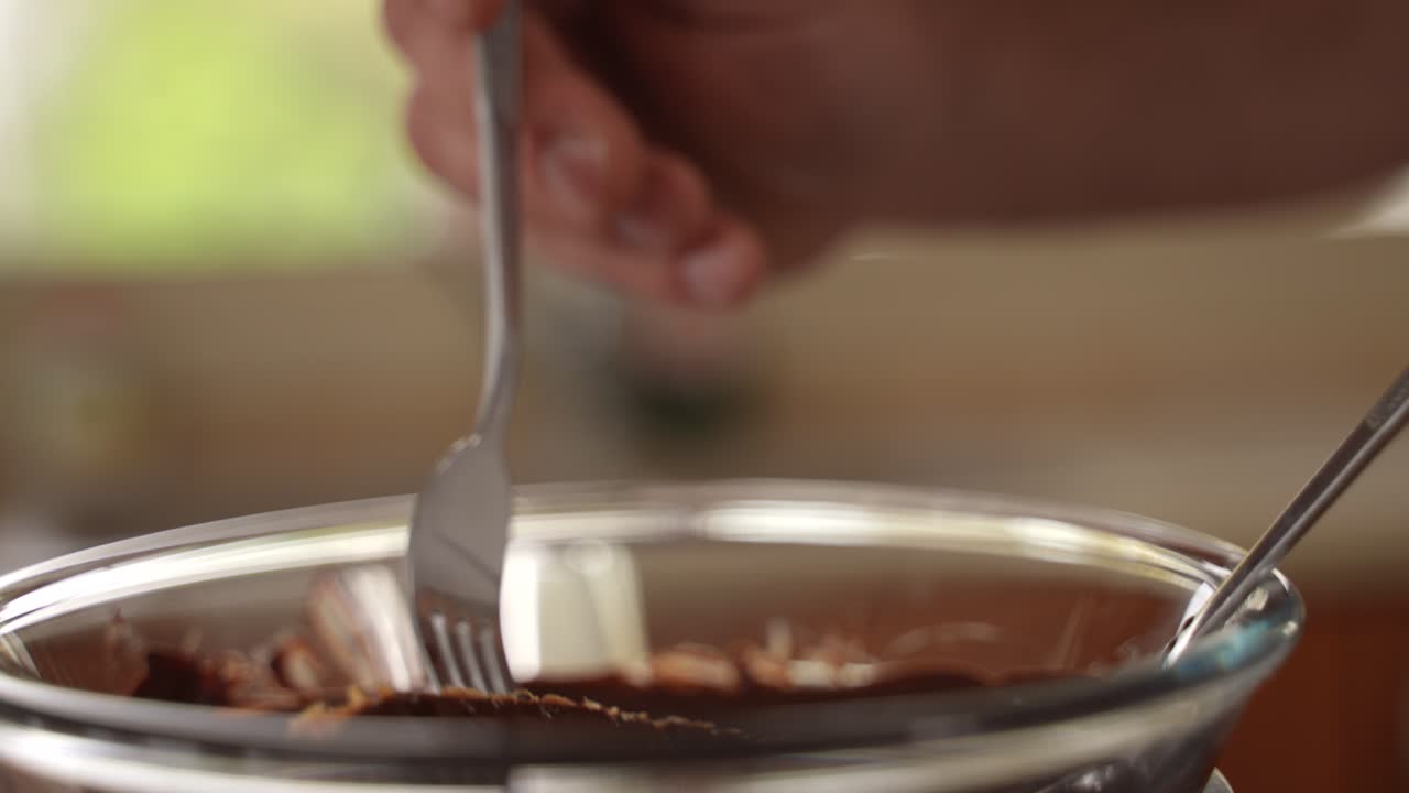 chef sumerge barra de proteína de avena casera en chocolate fundido, primer plano en cámara lenta