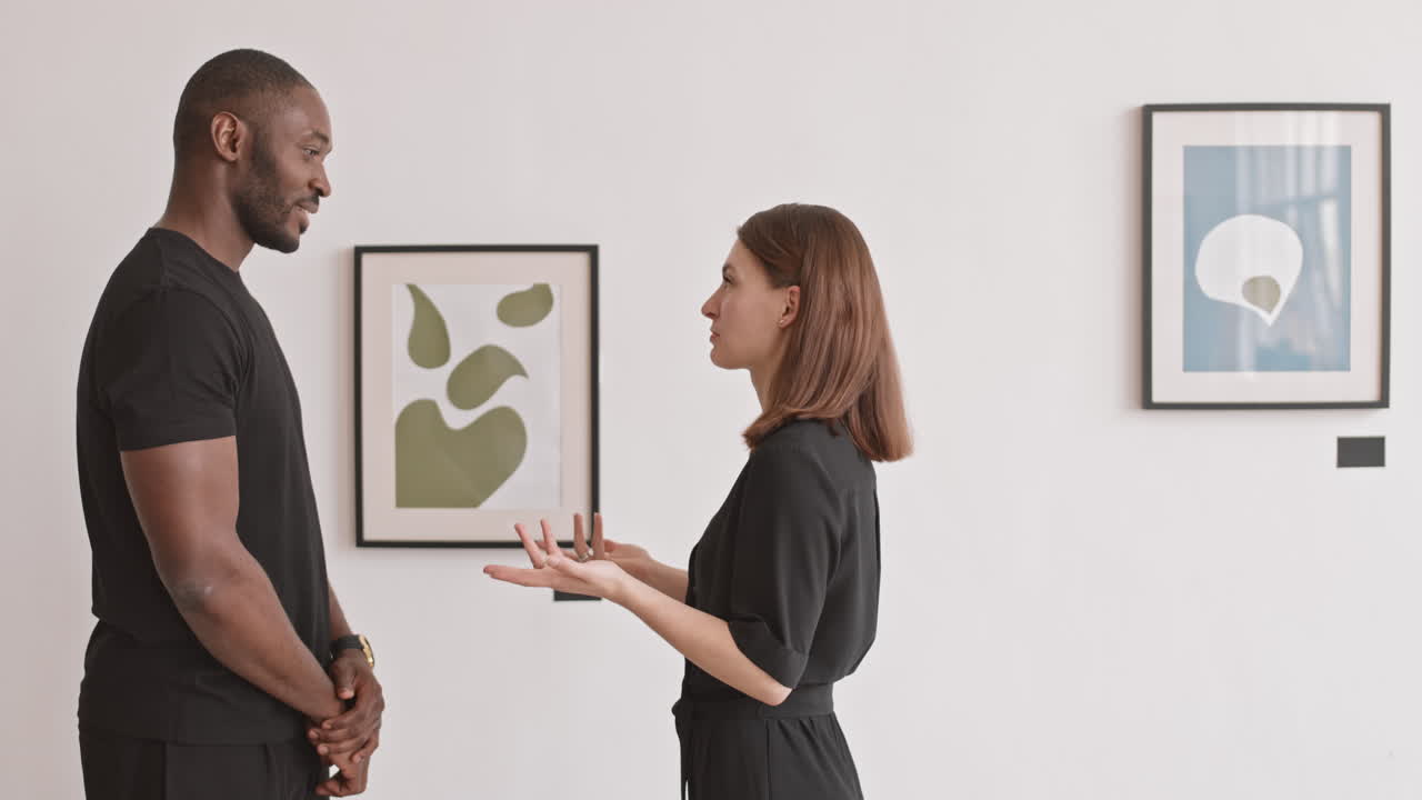 Multiethnic Couple Discussing Contemporary Painting