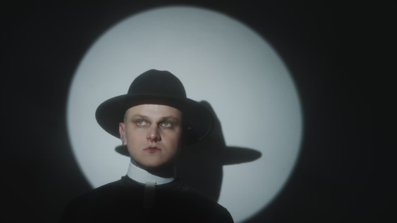 Spotlight Portrait of Queer Man in Priest Costume