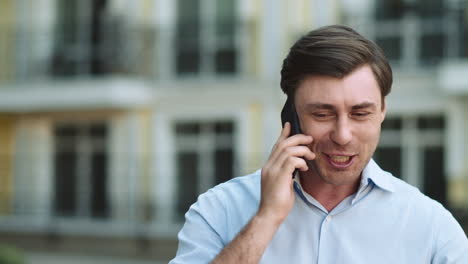 closeup businessman celebrating victory. man having phone talk at street