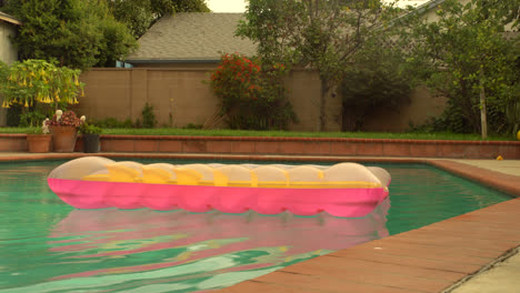 An-inflatable-lounger-floating-in-a-still-pool