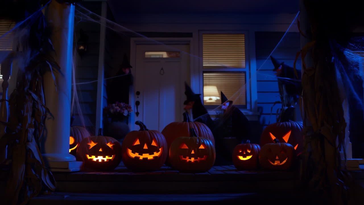 Halloween pumpkins on a decorated porch