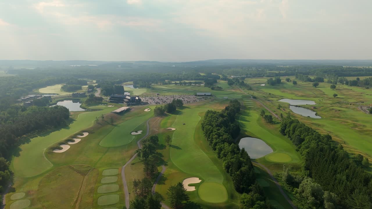 Smooth forward-moving aerial over the lush, mowed, and well-trimmed fairways of TPC Toronto Osprey Valley Golf Course in Alton, Caledon, Ontario, Canada