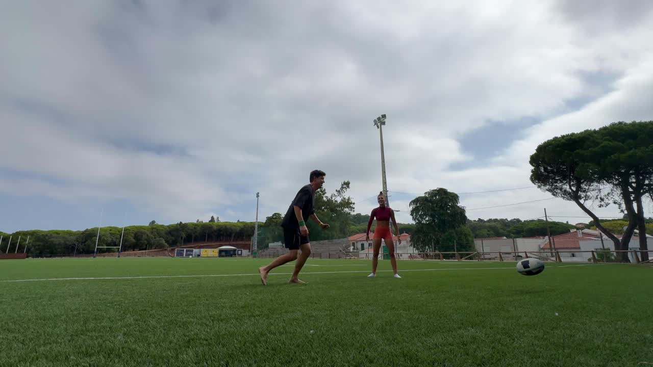 People playing sports on a rugby field