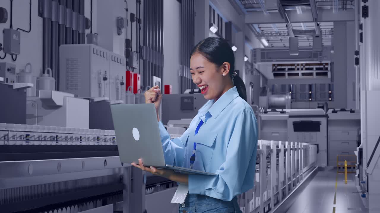 Side View Of Asian Female With Her Laptop At Pharmaceutical Factory, Vaccine Production Facility, She Raises Her Fist Up With Screaming Goal After Typed On The Laptop
