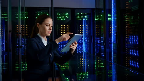 woman it professional working with tablet in a data center