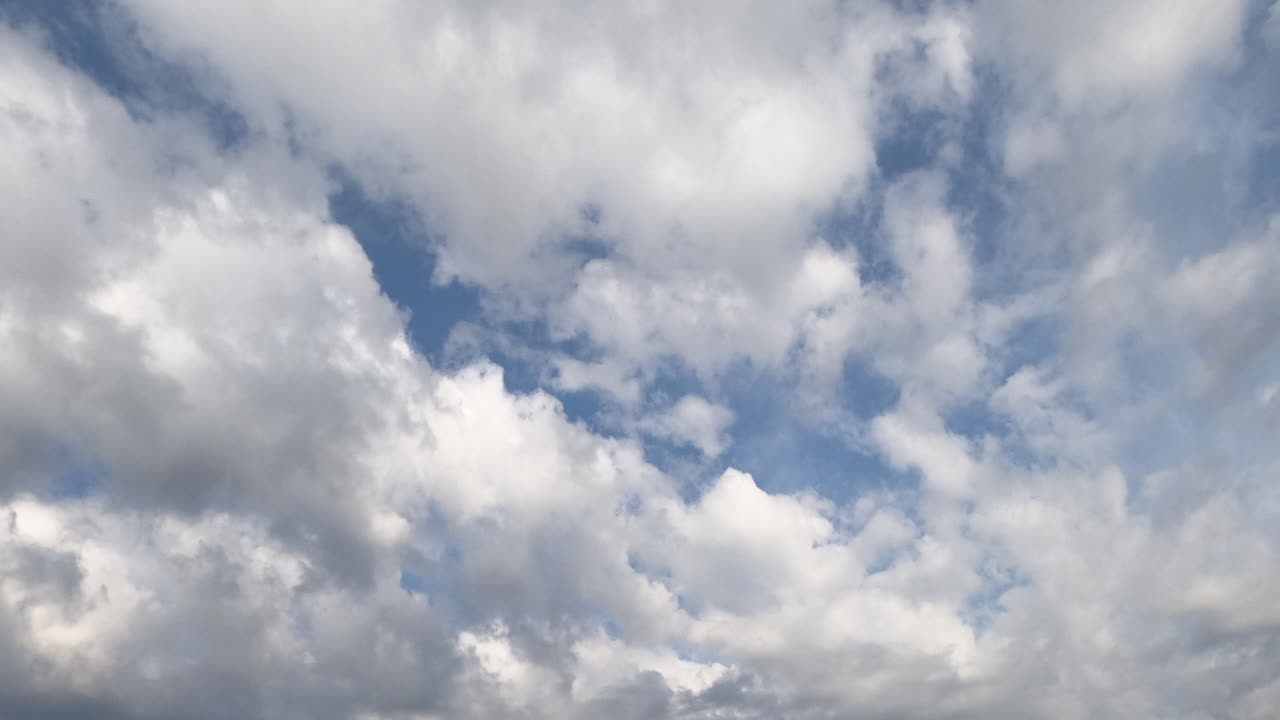 White soft cloudscape accumulating in the atmosphere. Rainy clouds gathering in the sky. Timelapse.