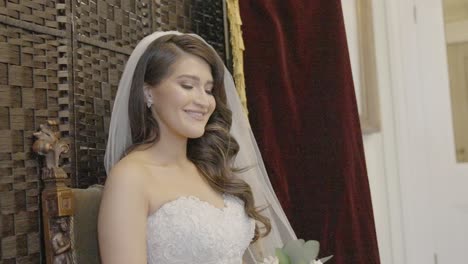 camera lights flashing on young bride's face as she is photographed