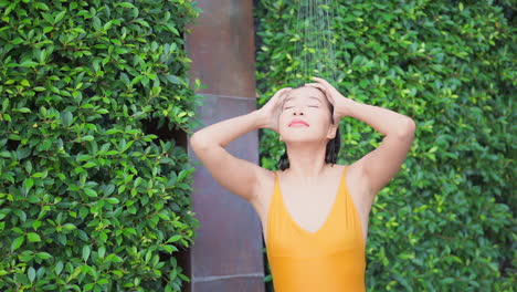 An-attractive-woman-fresh-from-a-swim-shower-off-sand-and-sea