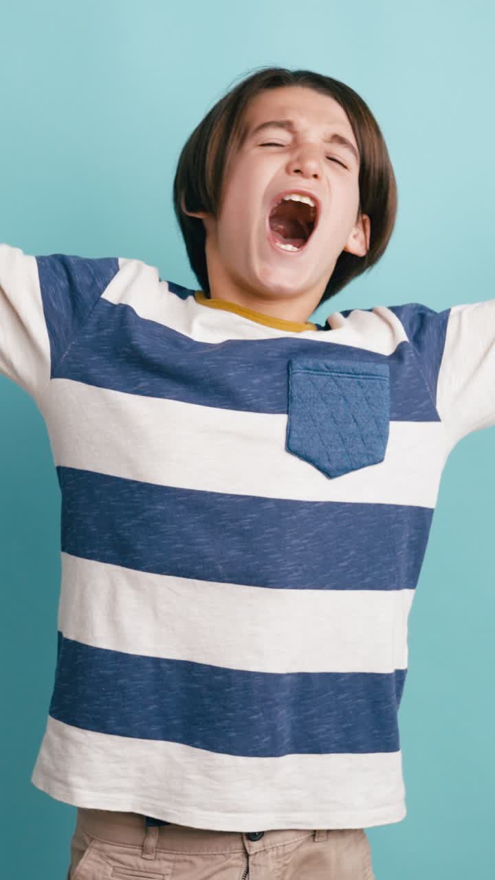 Sleepy Young Boy Yawning and Stretching on Blue Background