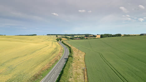 drone captures the uk countryside, from farms to fields to a winding country road