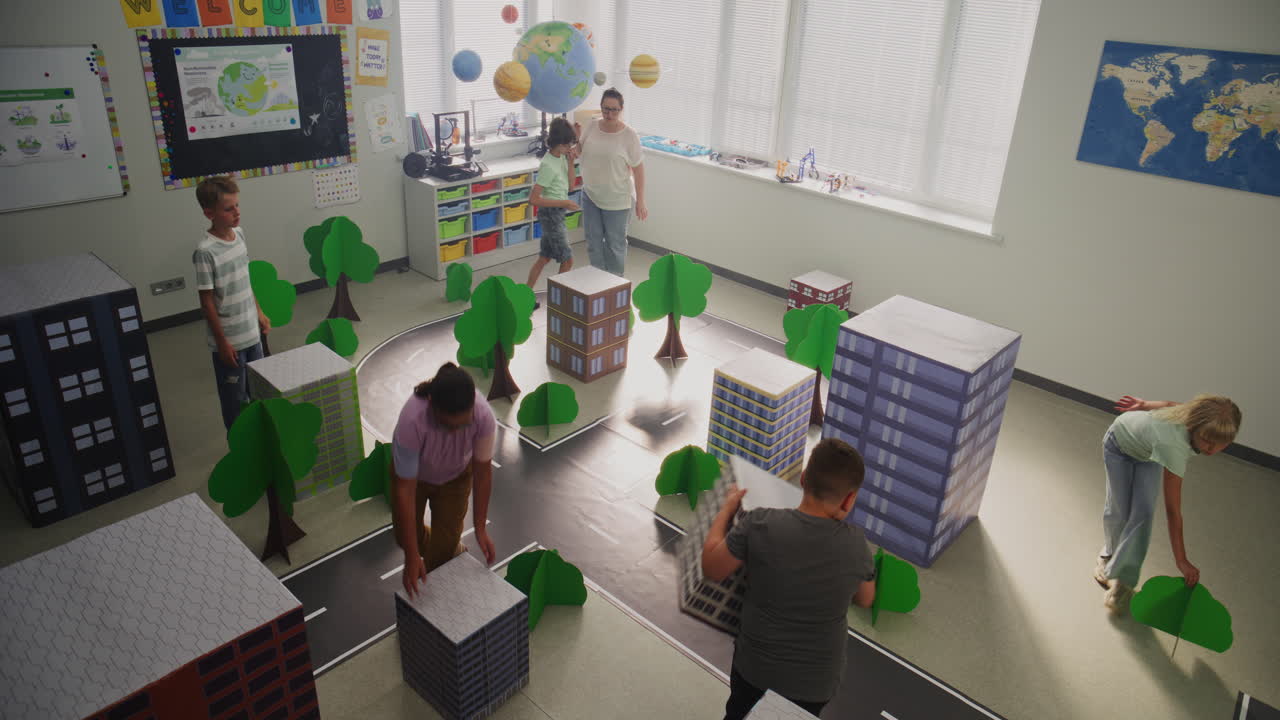 Team of Primary School Students Moving Blocks Creating City Planning