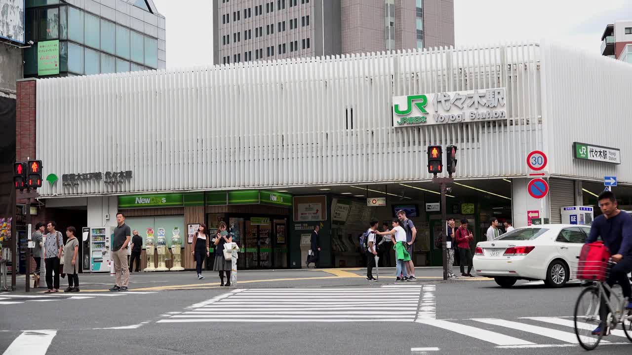 TOKYO, JAPAN - 8th Oct. 2018 : JR, Metro, Yoyogi Station, 4K, camera zoom, angle neutral.People and traffic at the entrance of the station. West exit Yoyogi station.
