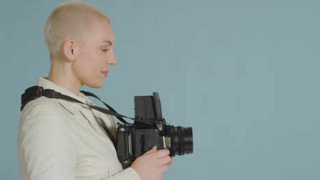 side view of female photographer using medium format film camera 03