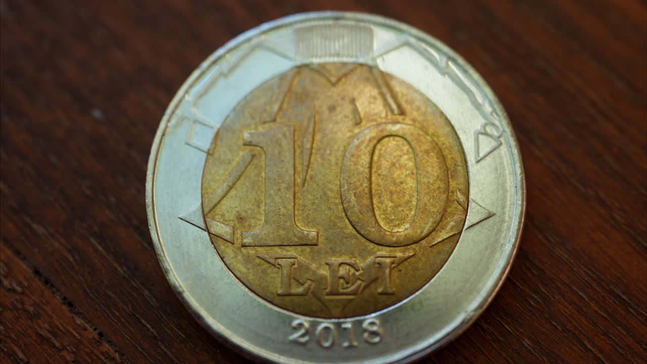 Close up of a 10 lei mdl coin on a wooden surface