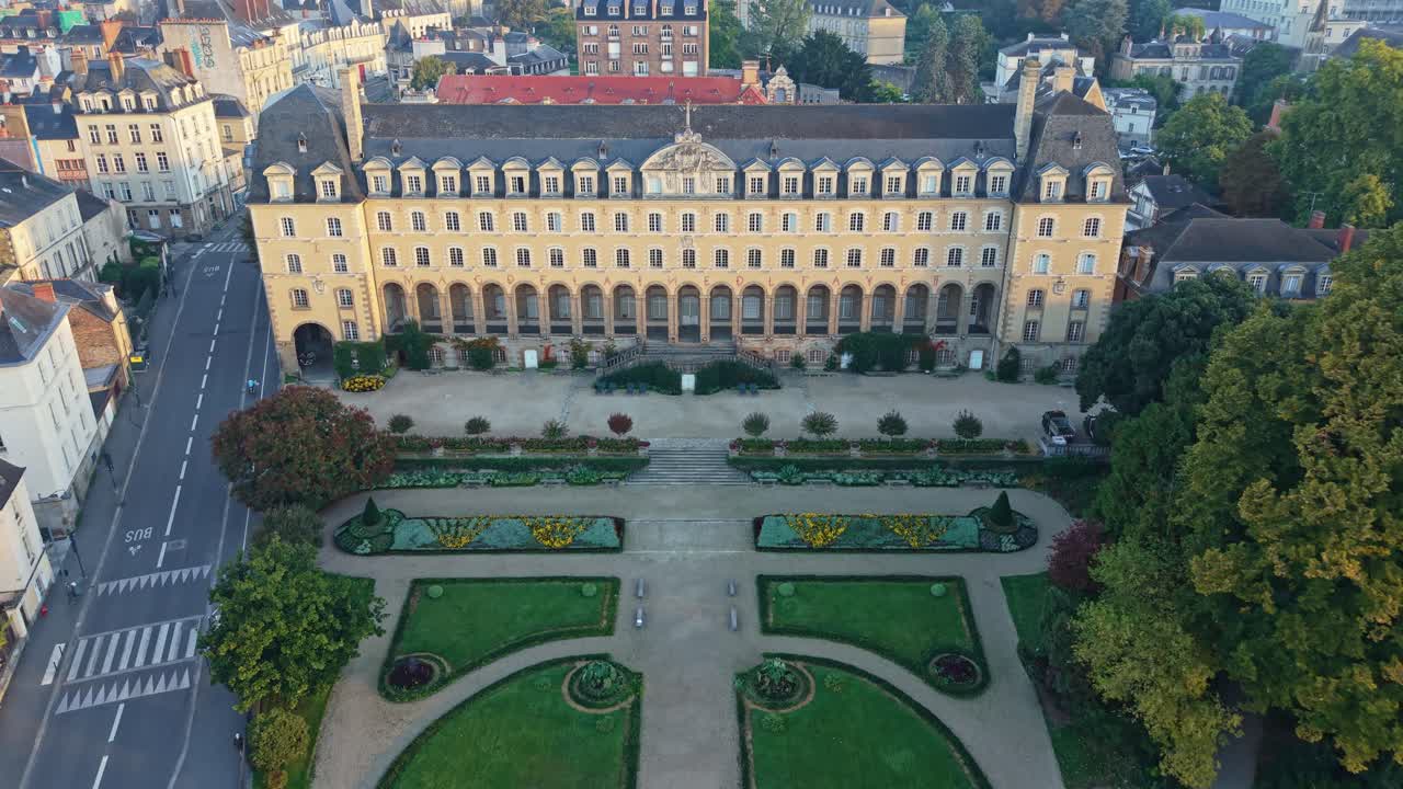 Drone advancing over Jardin and Palais Saint-Georges in Rennes, France during sunrise