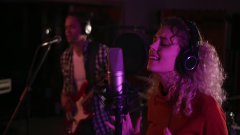 female singer singing in a music studio