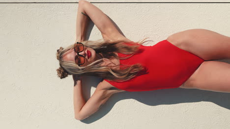 woman in a red swimsuit sunbathing