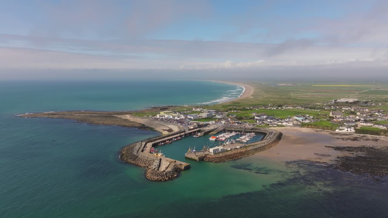 4K cinematic drone footage capturing Kilmore Quay, on a bright day, showcasing the picturesque harbour, and colourful fishing boats Co.Wexford - Ireland_005