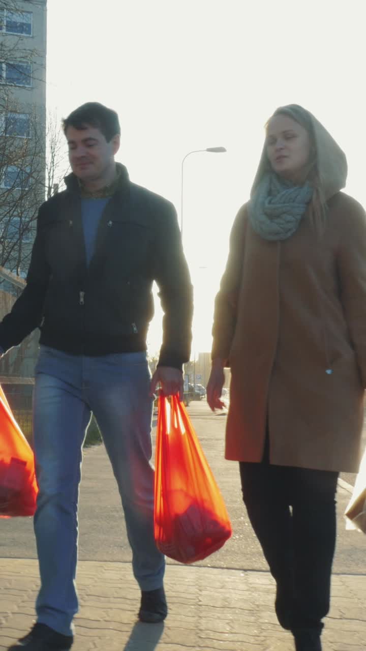 People walking with shopping bags on a city street