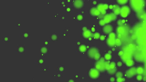 Green-glitters-and-particles-on-black-background