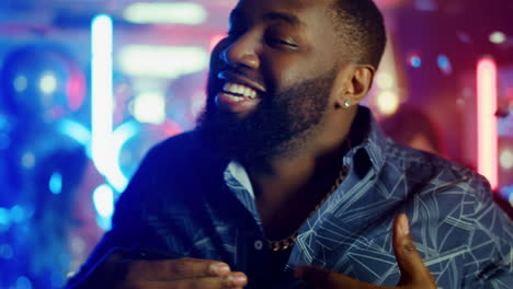 african american male person celebrating at party. cheerful man singing in club